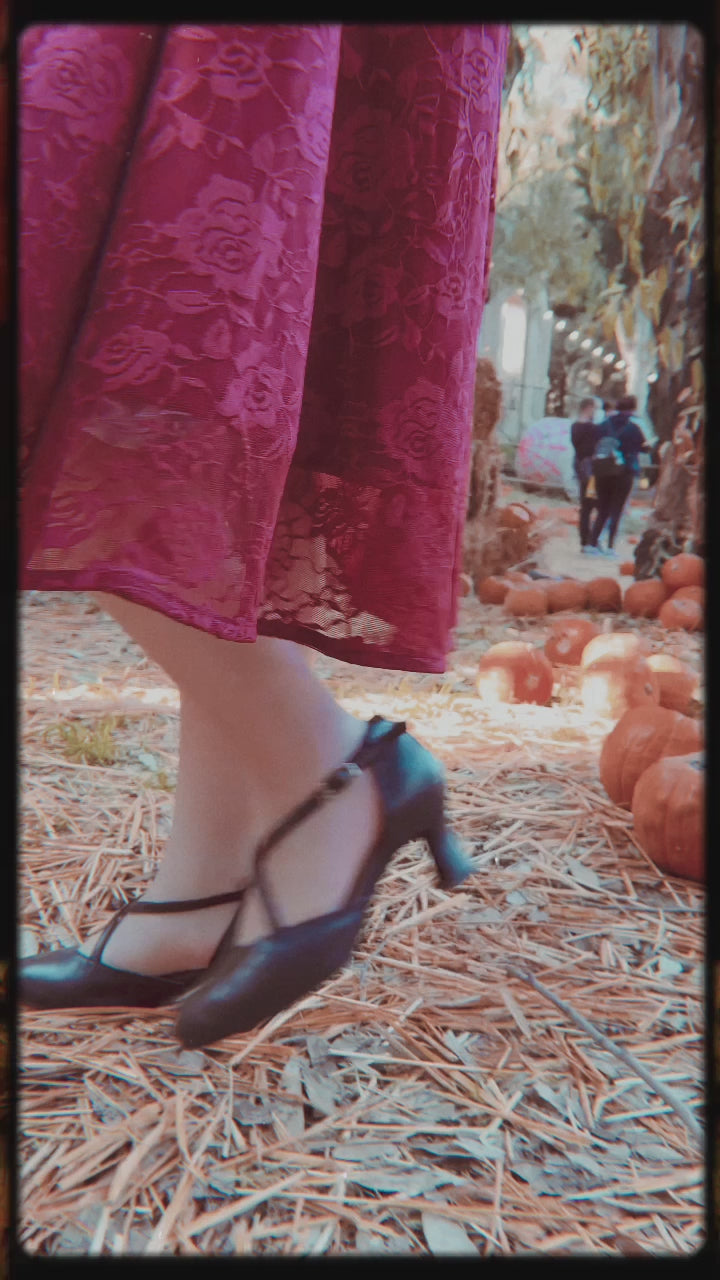 A video of miss_ladynoir wearing our  Madeline Long Sleeved Burgundy Lace Dress on a pumpkin field.