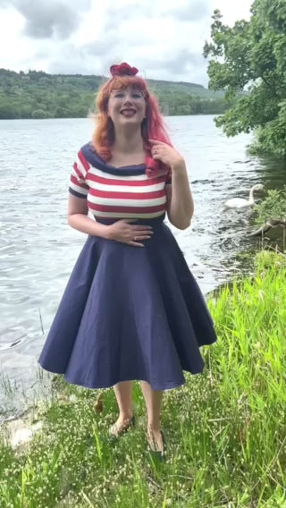 Video of Ms. AprilLuke wearing our Darlene Nautical Swing Dress in Navy with Red & White Stripes at a riverbank.