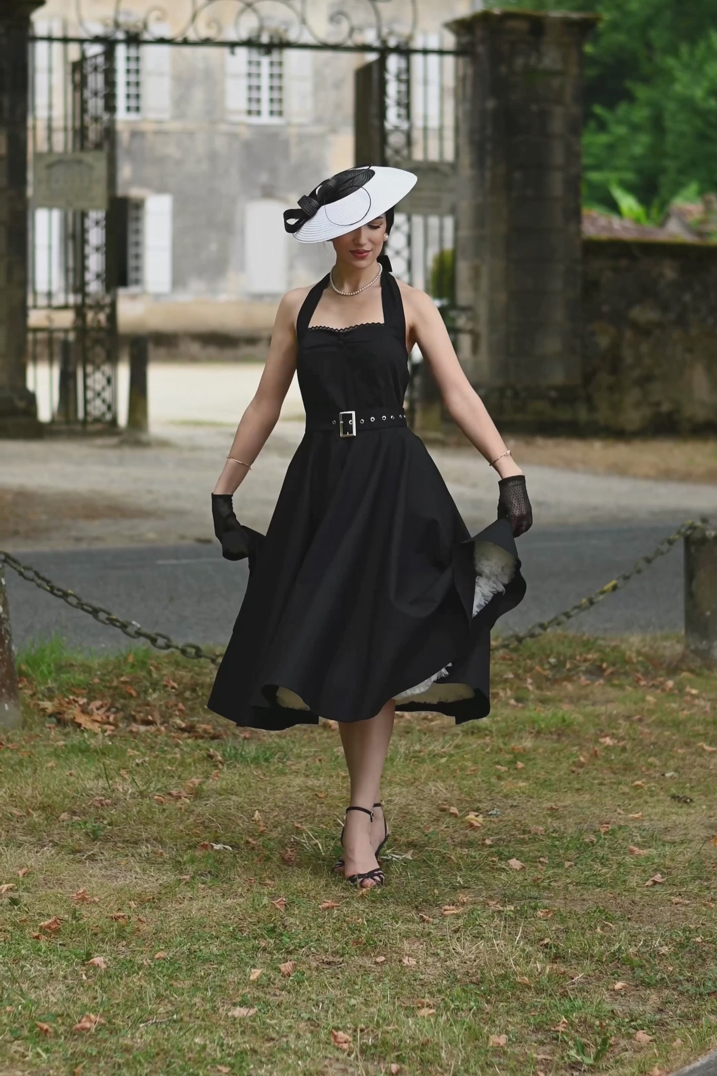 A video of a model wearing a Daisy Classic Black Halter Dress