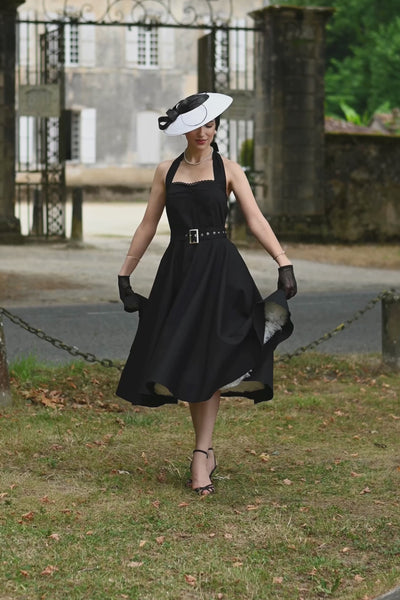 A video of a model wearing a Daisy Classic Black Halter Dress