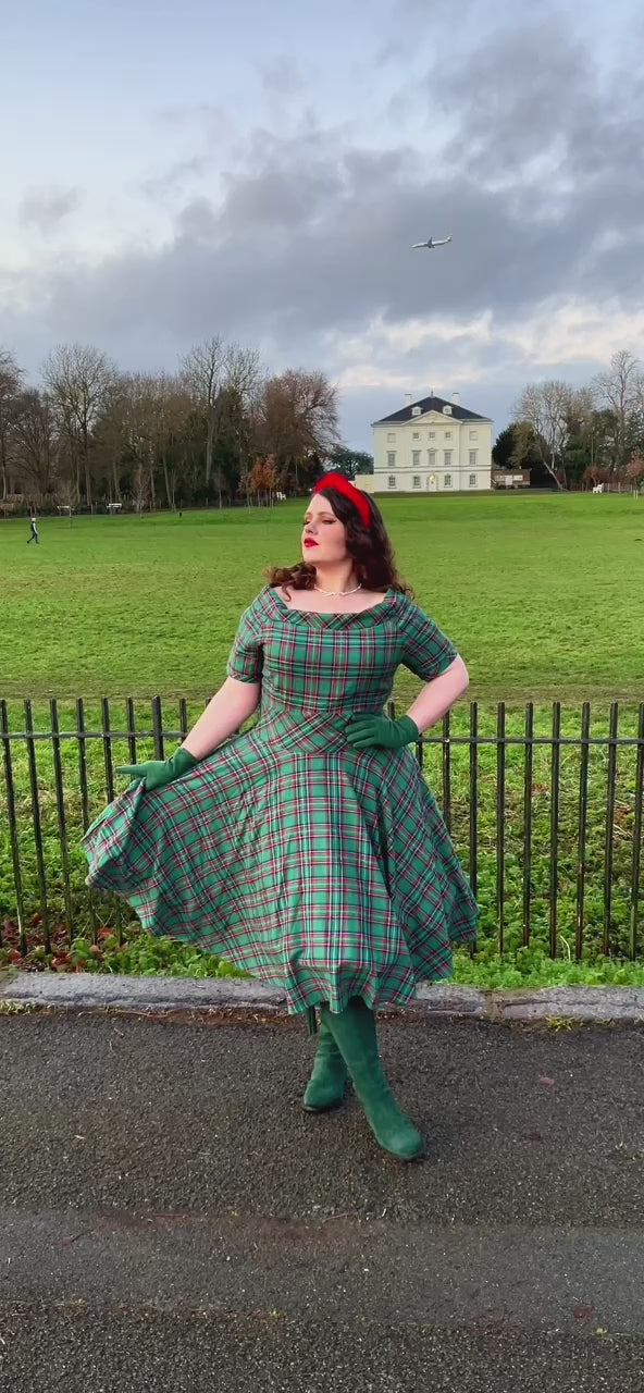 Video of a model twirling, wearing  a Green Tartan Dress