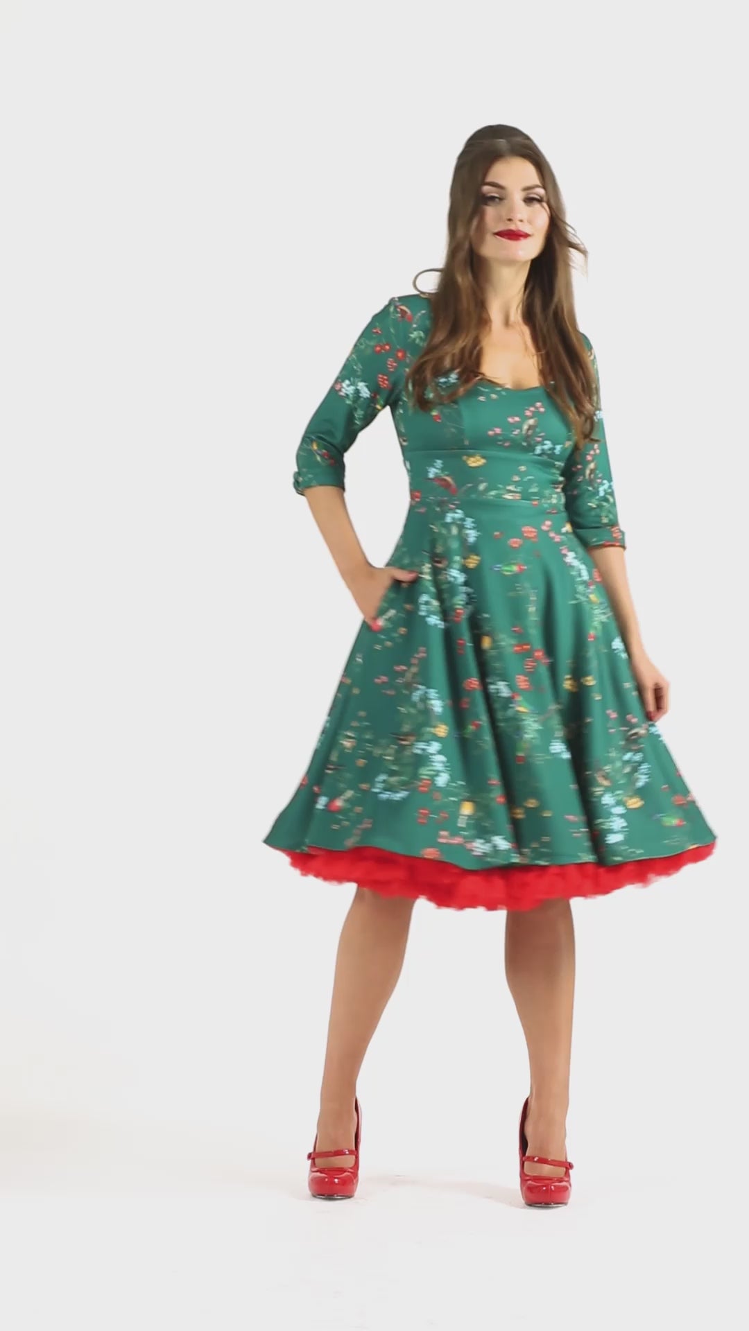 Video of a model wearing a 50s-Style Green Long-Sleeved dress with Bird Print.