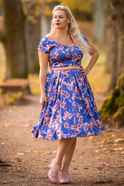 A lady wearing a Purple Alstroemeria Off Shoulder Dress