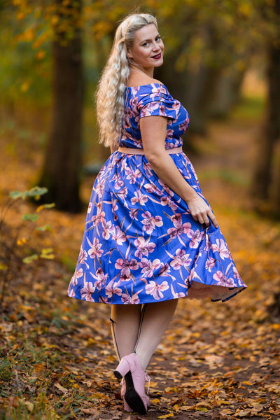 A lady wearing a Purple Alstroemeria Off Shoulder Dress