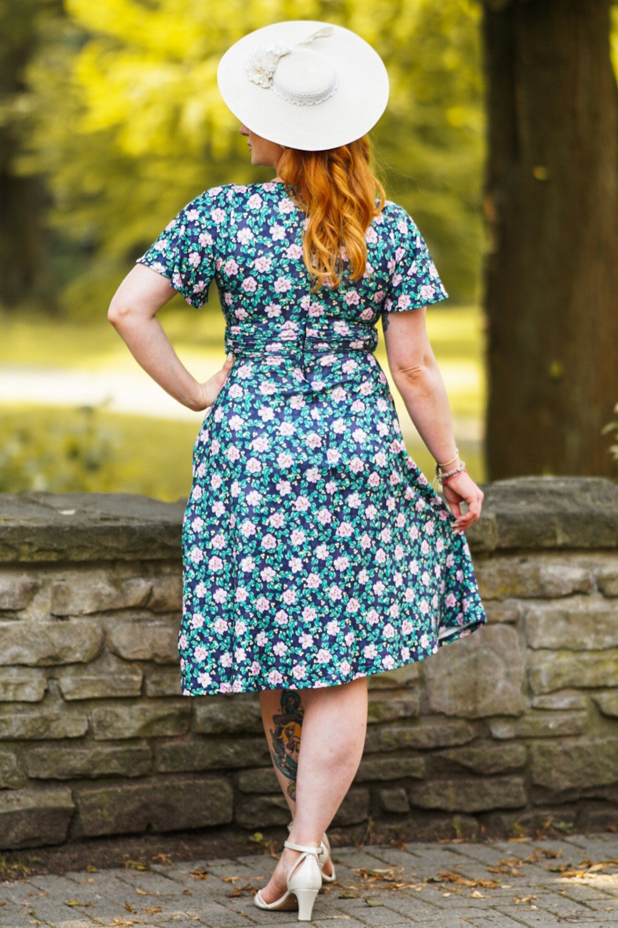 A model wearing a Purple Floral Crossover Bust Dress