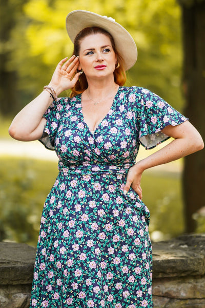 A model wearing a Purple Floral Crossover Bust Dress