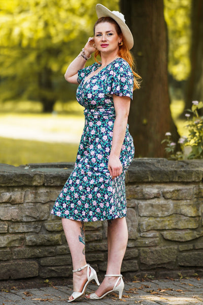A model wearing a Purple Floral Crossover Bust Dress