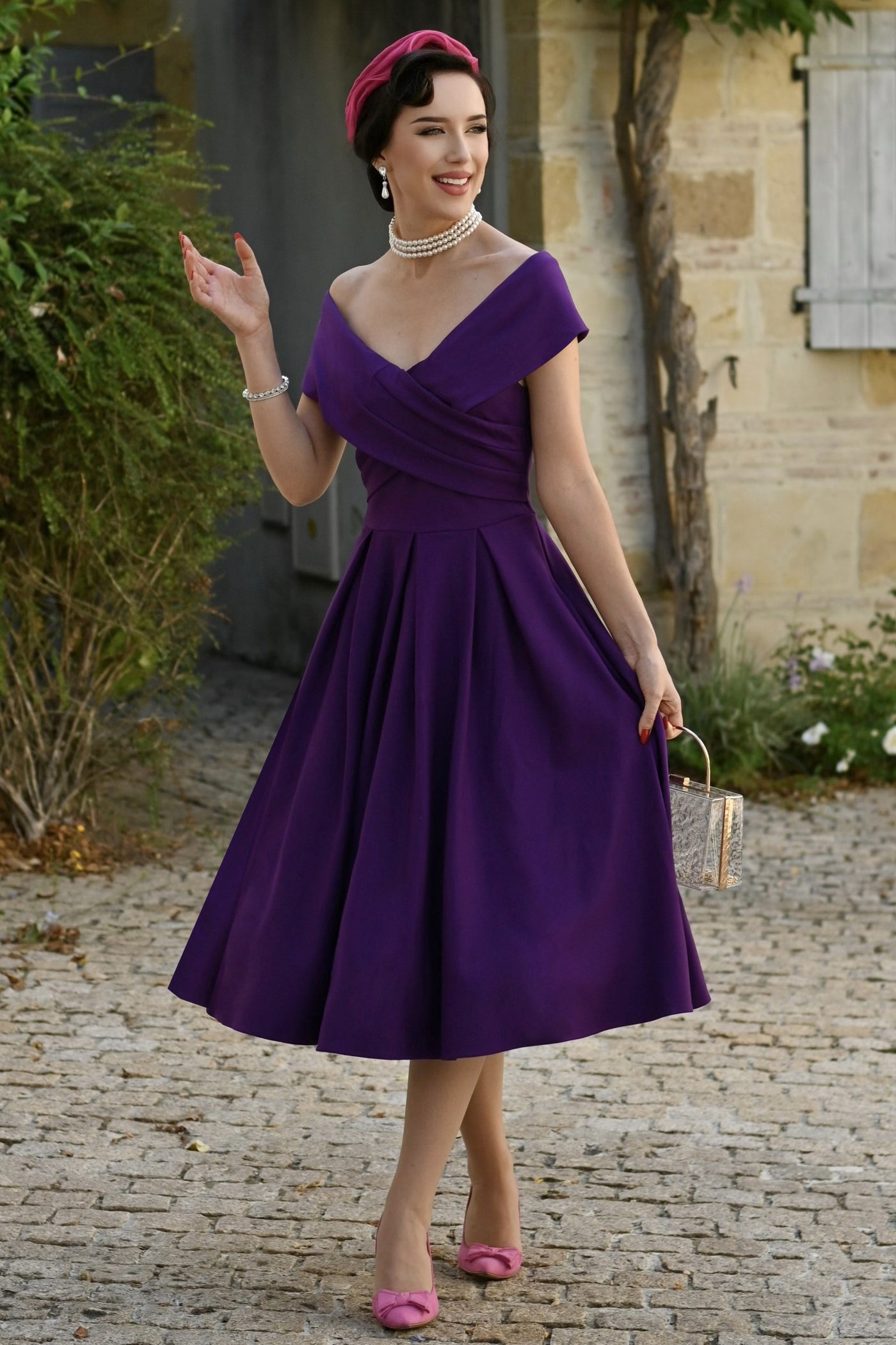 A lady wearing a Purple Off Shoulder Dress