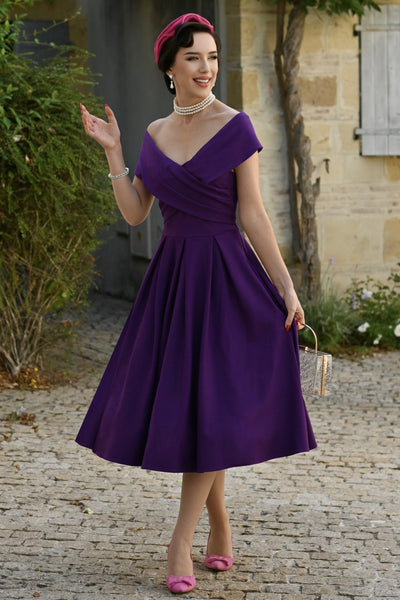 A lady wearing a Purple Off Shoulder Dress