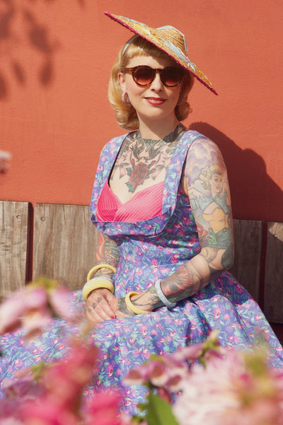 A model wearing Purple Pleated Dress in Flamingo Leaf Print