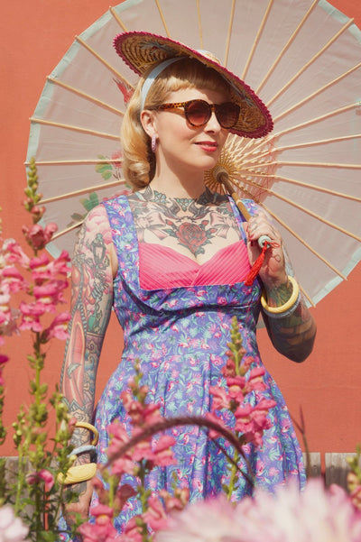 A model wearing Purple Pleated Dress in Flamingo Leaf Print