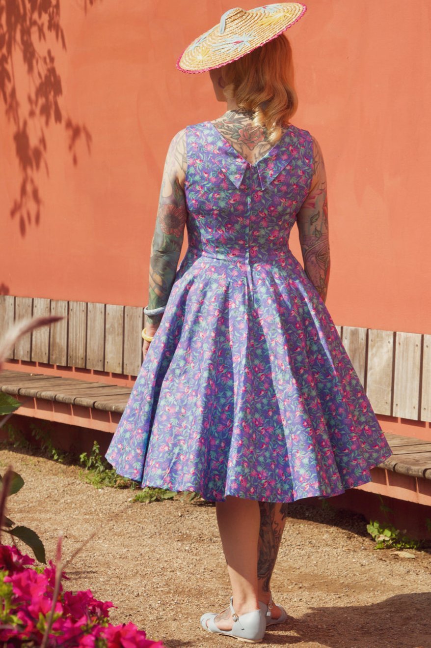 A model wearing Purple Pleated Dress in Flamingo Leaf Print