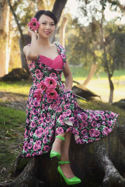 A lady wearing a Purple Poppy Pleated Bust Dress