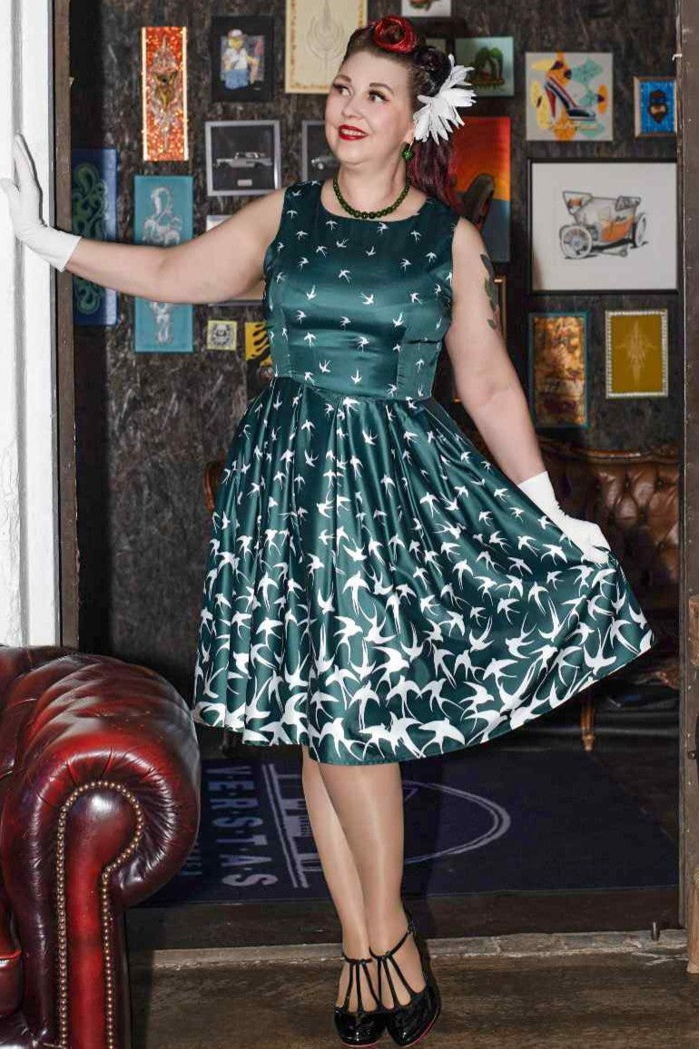 A lady wearing a Raising Bird Swing Dress in Green