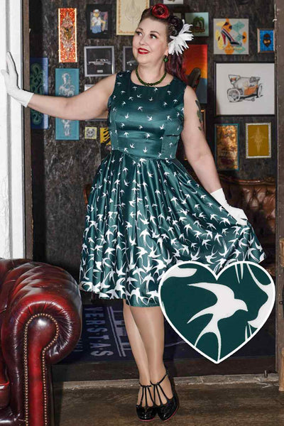 A lady wearing a Raising Bird Swing Dress in Green