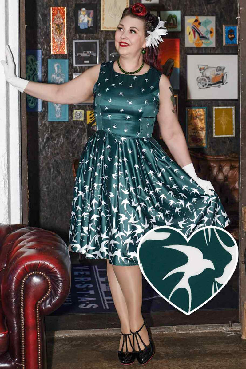 A lady wearing a Raising Bird Swing Dress in Green