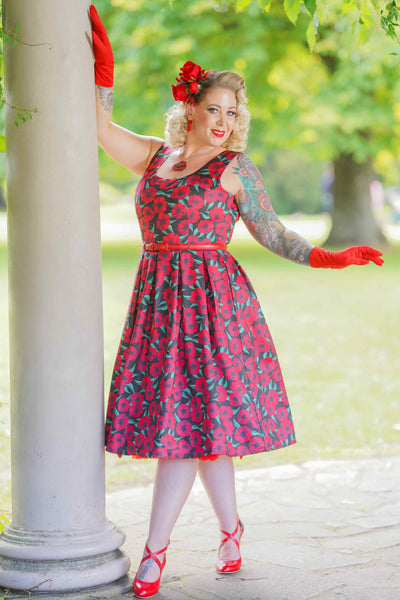 A lady wearing a Red Anemone Swing Dress