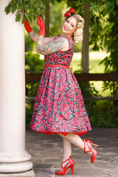 A lady wearing a Red Anemone Swing Dress