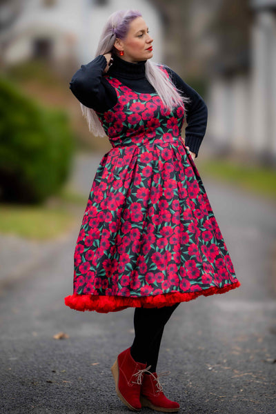 A lady wearing a Red Anemone Swing Dress