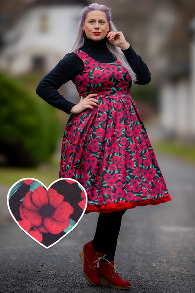 A lady wearing a Red Anemone Swing Dress