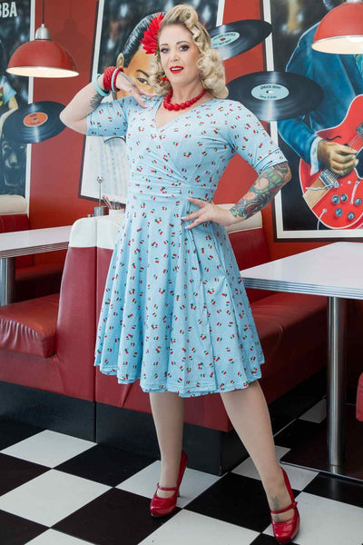 A model wearing Red Cherry Blue Wrap Dress