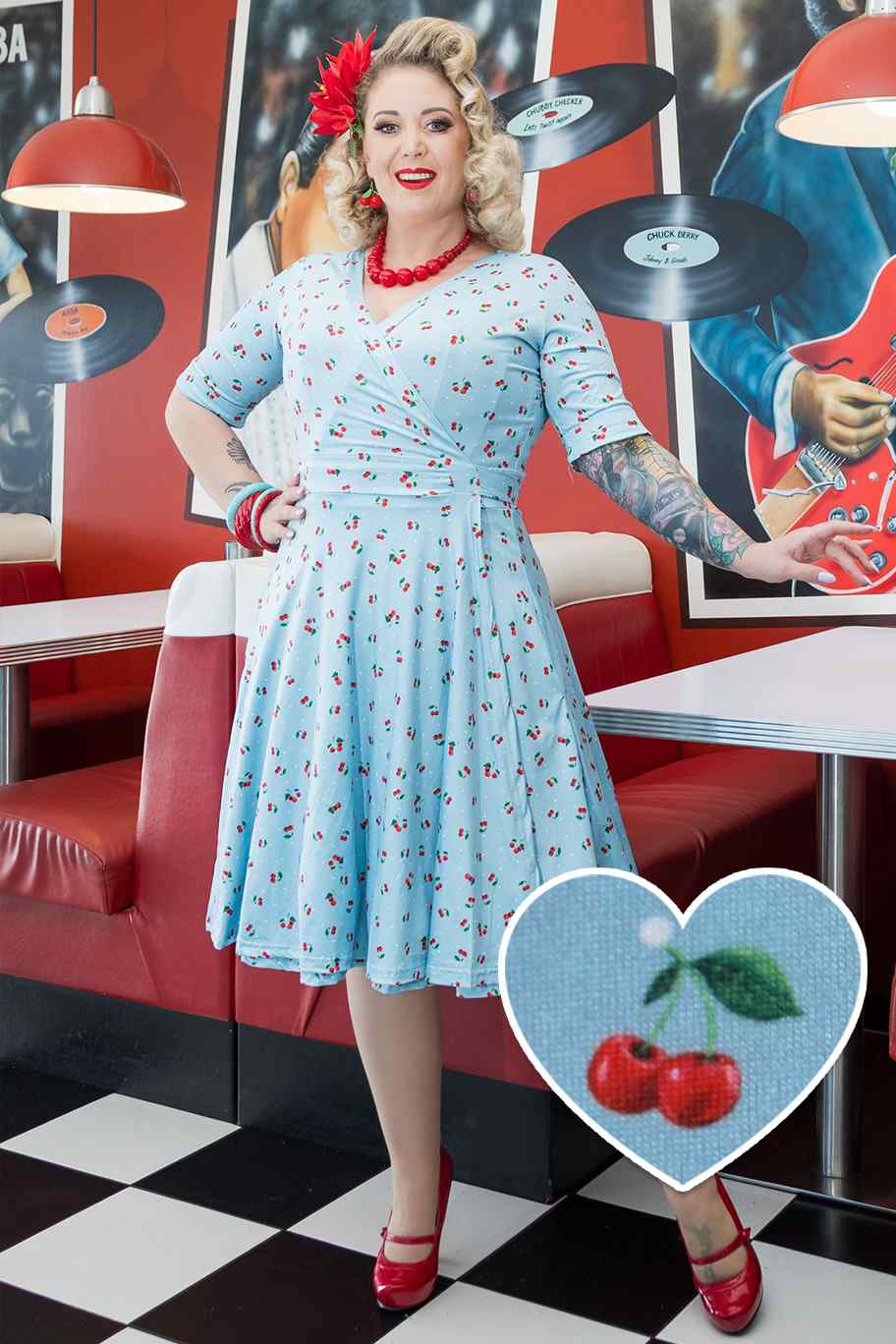 A model wearing Red Cherry Blue Wrap Dress