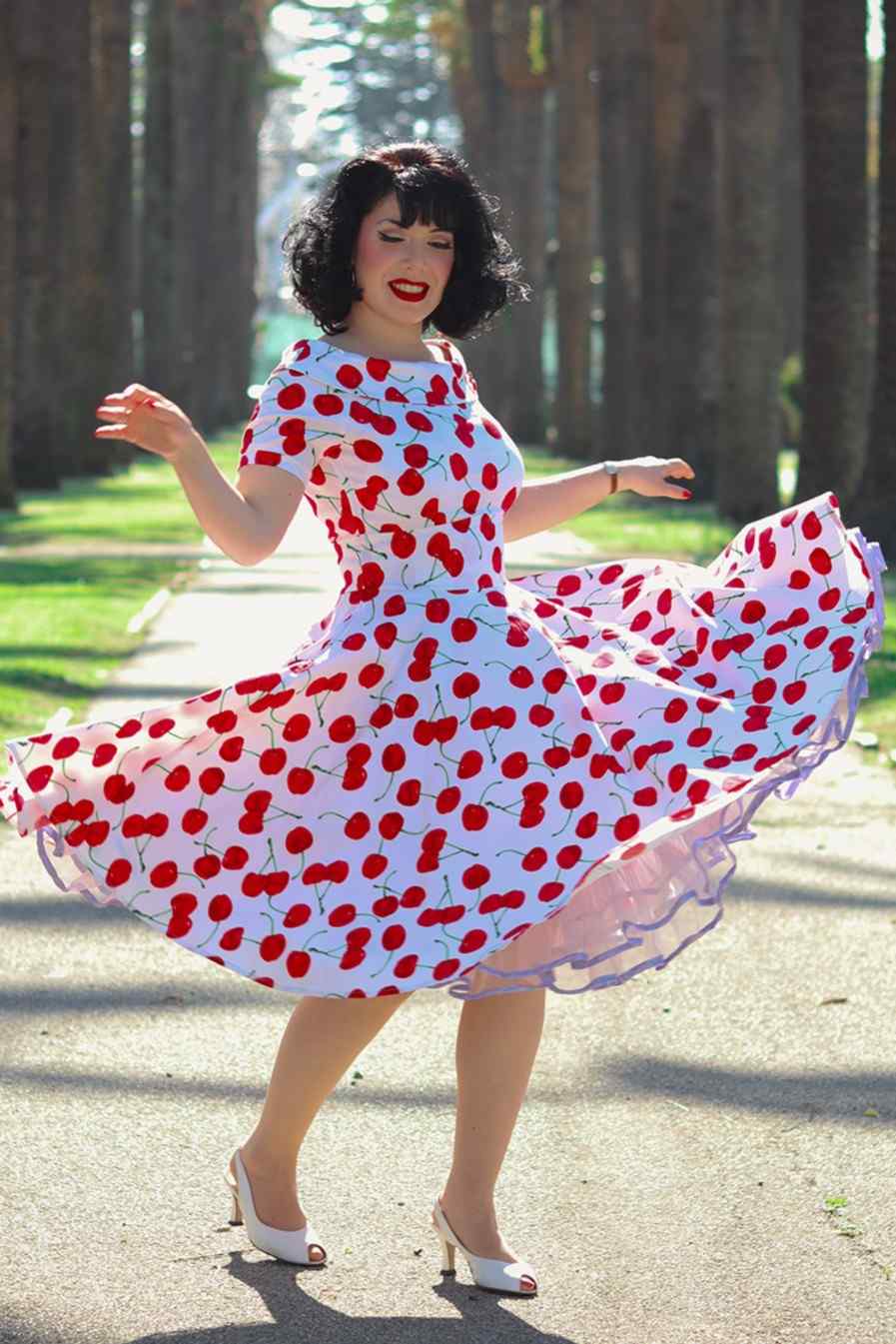 A lady wearing a Red Cherry Dress In White