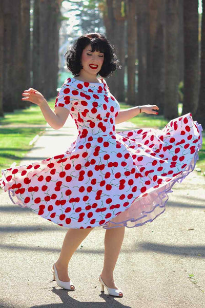 A lady wearing a Red Cherry Dress In White