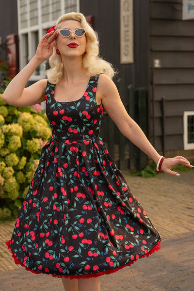A model wearing a Red Cherry Pleated Circle Dress In Black