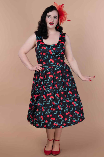 A model wearing a A model wearing a Red Cherry Pleated Circle Dress In Black