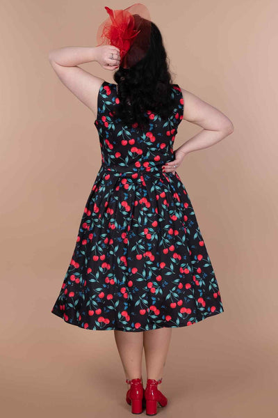 A model wearing a A model wearing a Red Cherry Pleated Circle Dress In Black