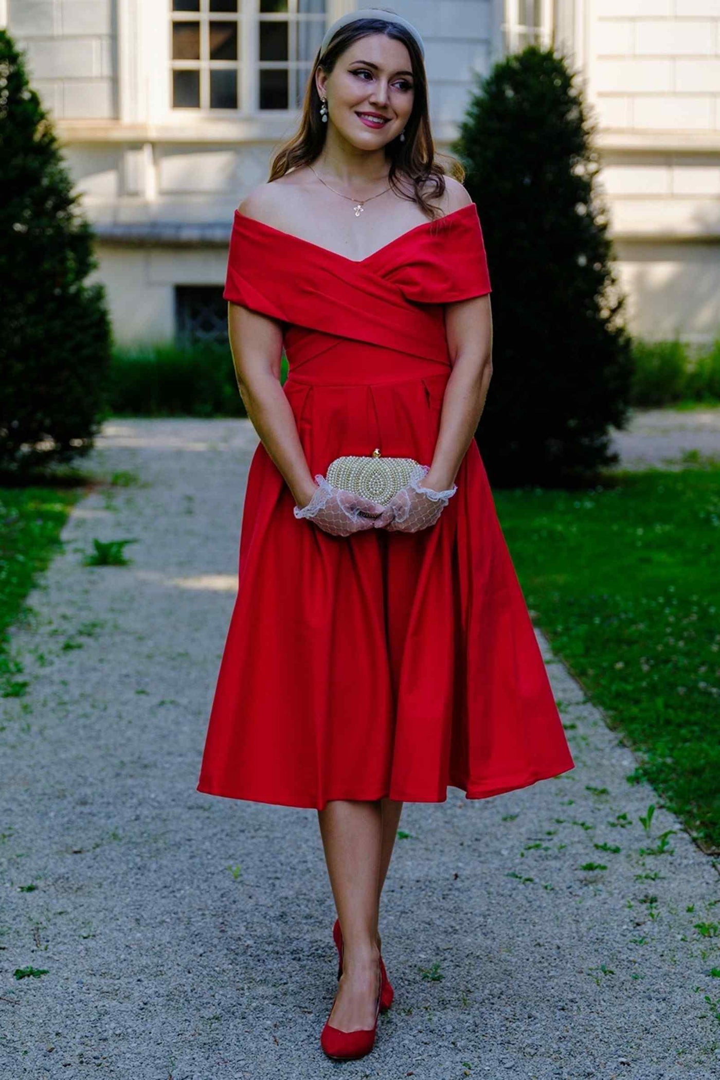 A lovely model wearing a Beverly Red Off Shoulder Dress