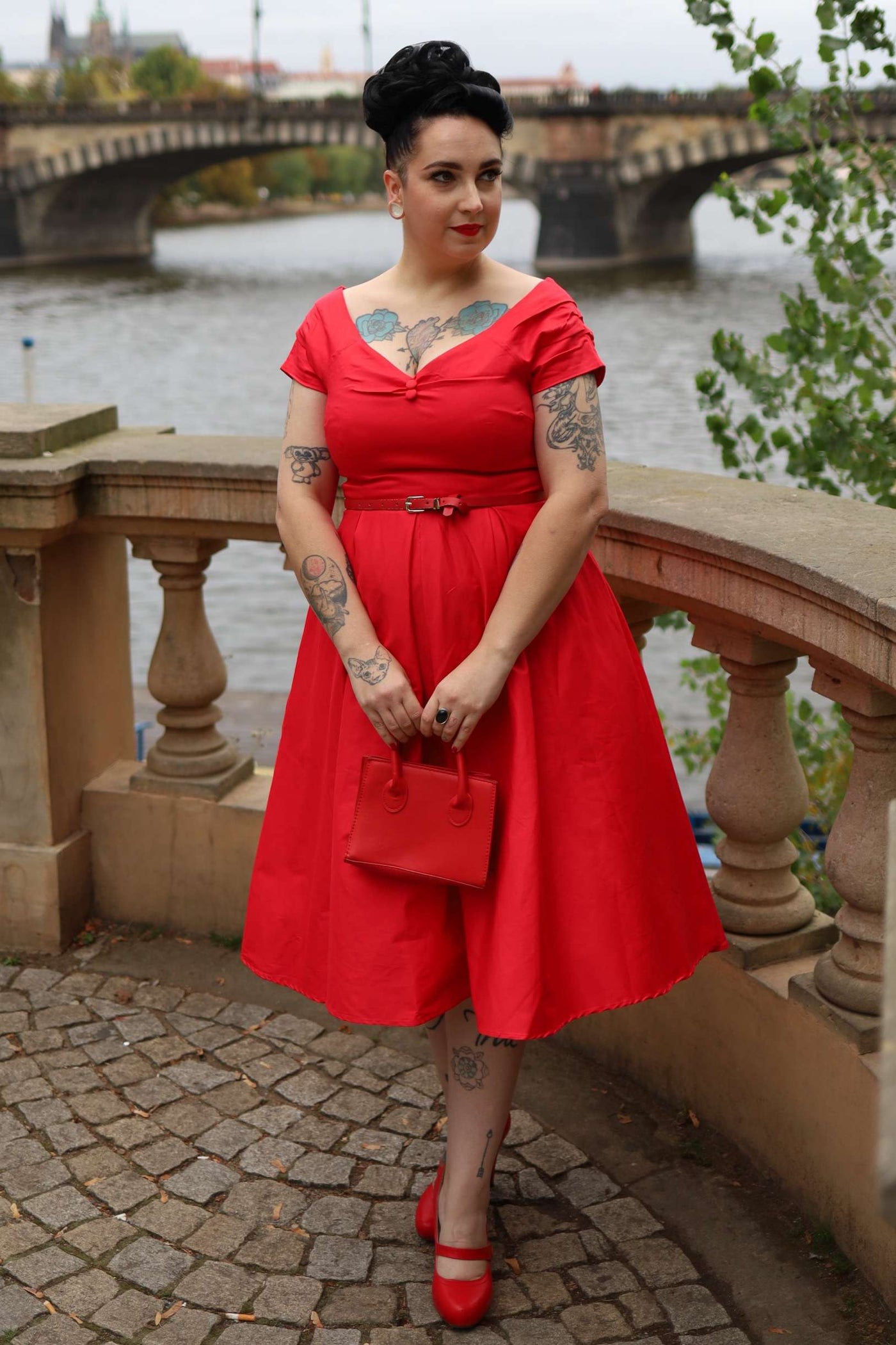 A model wearing a Lily Red Off Shoulder Midi Dress