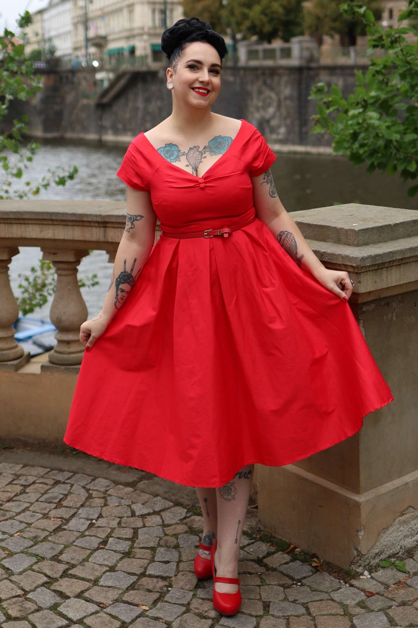 A lady wearing a Lily Red Off Shoulder Midi Dress