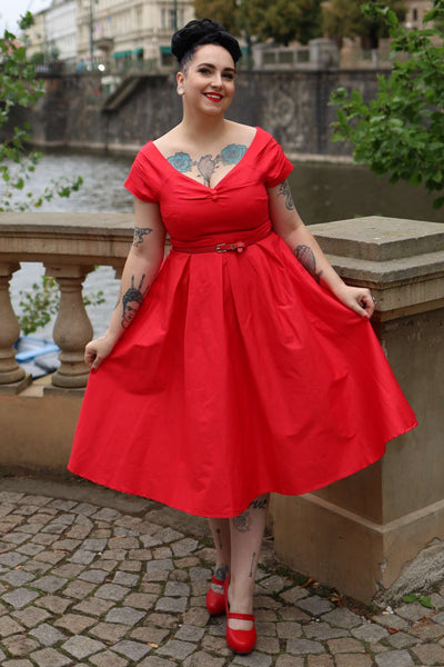 A lady wearing a Lily Red Off Shoulder Midi Dress