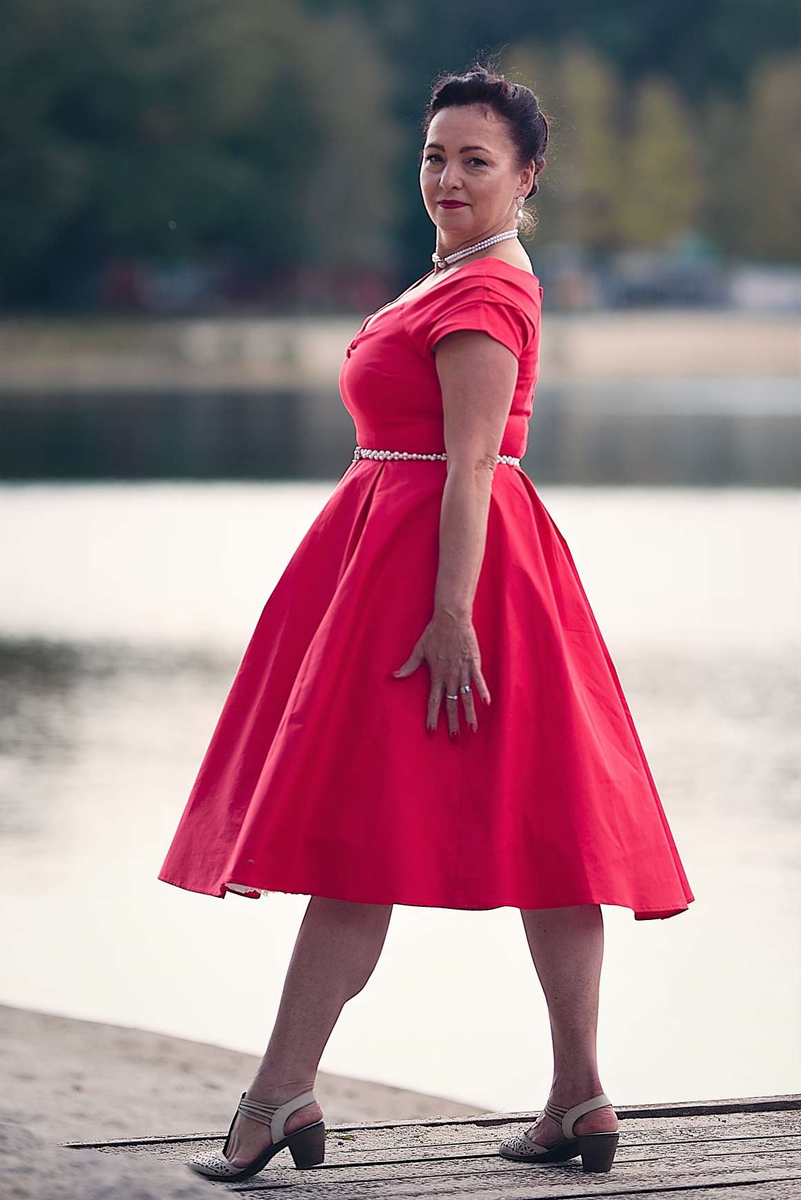 A woman wearing a Lily Red Off Shoulder Midi Dress