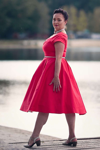 A woman wearing a Lily Red Off Shoulder Midi Dress