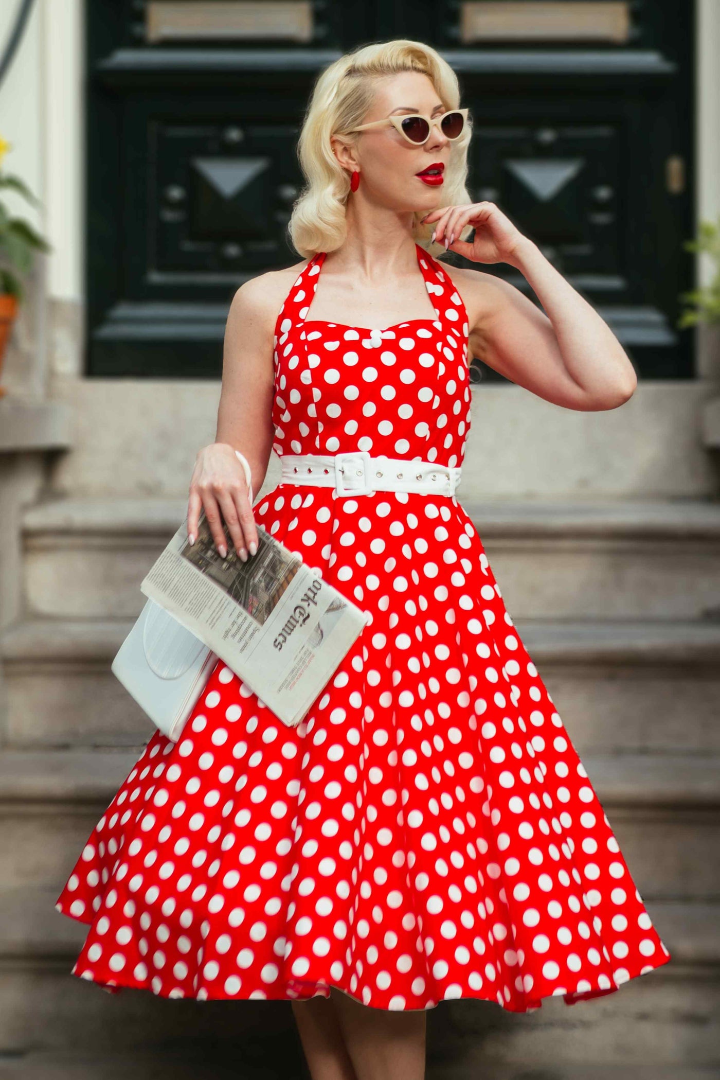 A woman wearing a Red Polka Dot Halter Dress