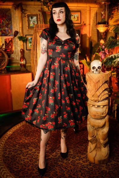 A lady wearing a Red Rose & Bird Off Shoulder Dress In Black