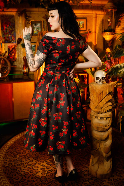 A lady wearing a Red Rose & Bird Off Shoulder Dress In Black