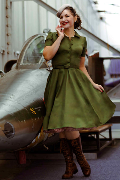 A lady wearing a Penelope Retro Army Green Shirt Dress
