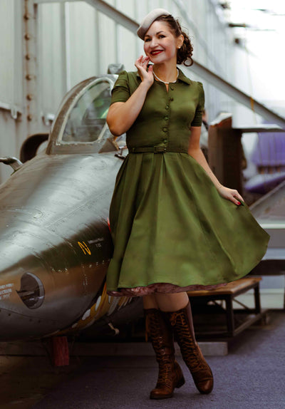A lady wearing a Penelope Retro Army Green Shirt Dress