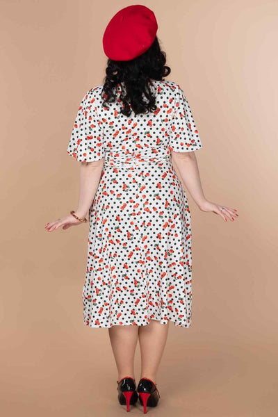 A model wearing a Retro Cherry Polka Dot Dress