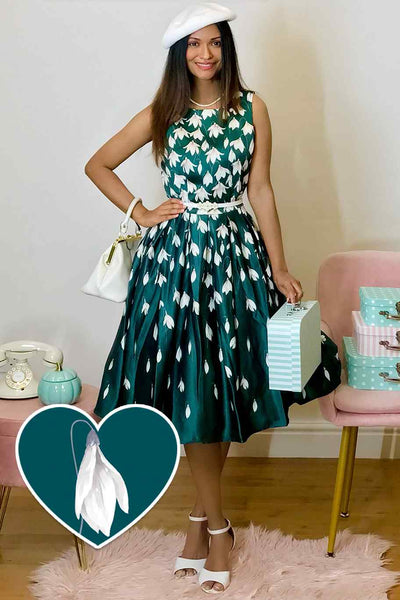 A lady wearing a Retro Flared Dress in Myrtle Green with Snowdrop Tulip Print