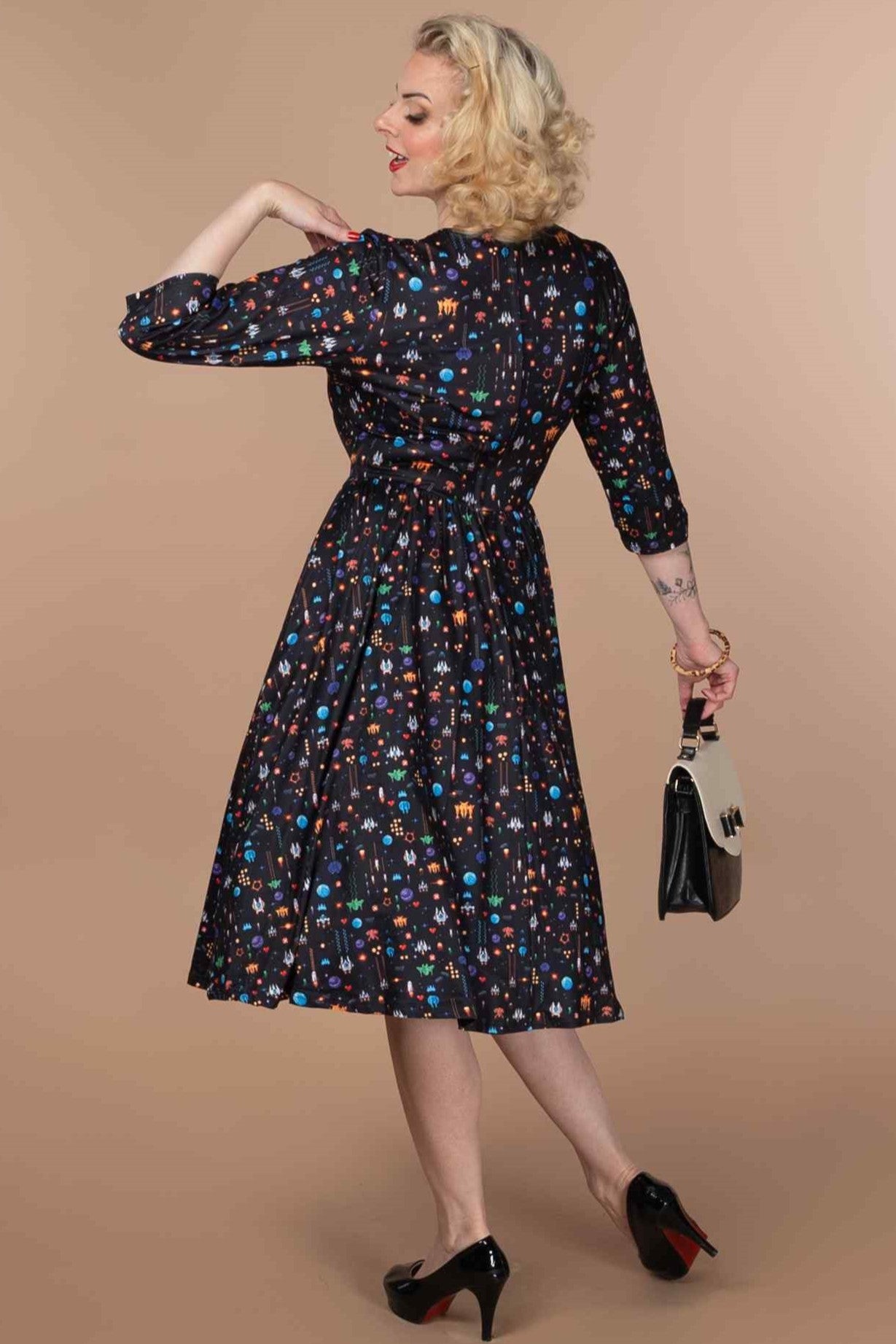 A lady wearing a Retro Game Print Dress In Black