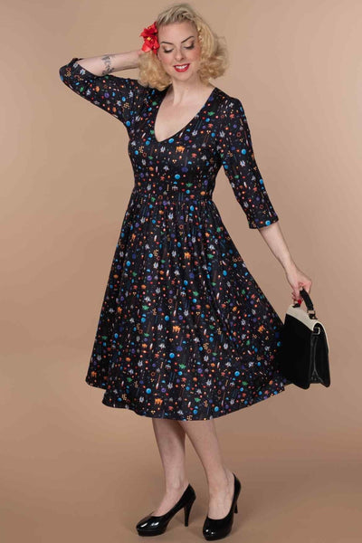 A lady wearing a Retro Game Print Dress In Black