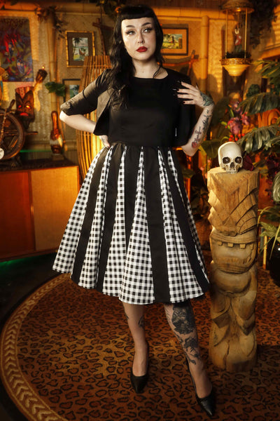 A model wearing a Retro Pleated Black Dress With Gingham Check