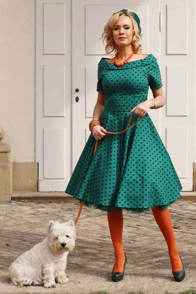 A lady wearing a Retro Polka Dot Swing Dress in Dark Green