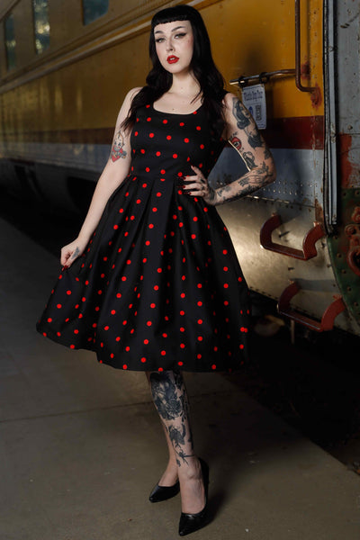A model wearing Retro Polka Dot Swing Dress in Black & Red