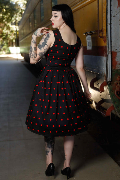 Back view of model wearing Retro Polka Dot Swing Dress in Black & Red